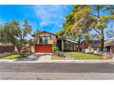 Two story house with red door and large yard at 4415 Flowerdale Ct, Las Vegas, NV 89103