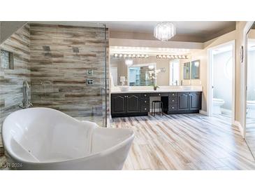 Elegant bathroom with soaking tub, double vanity, and walk-in shower at 8100 Lake Hills Dr, Las Vegas, NV 89128