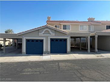 Two-car garage with covered parking and stucco exterior at 2211 Rugged Mesa Dr, Laughlin, NV 89029