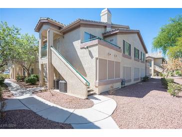 Two story condo building with walkway and landscaping at 5710 E Tropicana Ave # 1112, Las Vegas, NV 89122