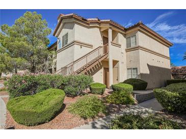 Two-story building with stairs, landscaping, and walkway at 8501 W University Ave # 1119, Las Vegas, NV 89147