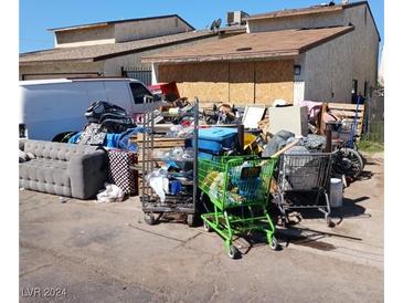 Front yard with various debris and junk at 1205 Mews Ln # 0, Las Vegas, NV 89101