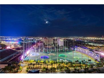 Night aerial view of Topgolf and surrounding area at 125 E Harmon Ave # 1902, Las Vegas, NV 89109