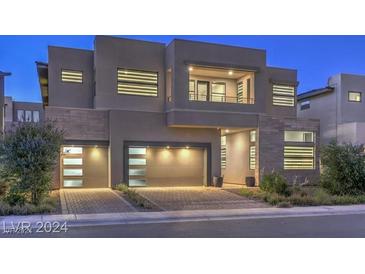 Modern two-story home with a two-car garage and landscaped yard at 10736 Patina Hills Ct, Las Vegas, NV 89135