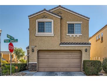 Two story home with tan exterior and a two car garage at 5662 Point Loma Ct, Las Vegas, NV 89122