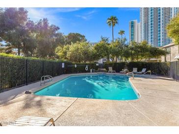 Inviting community pool with surrounding lounge chairs and trees at 656 Tam O Shanter, Las Vegas, NV 89109