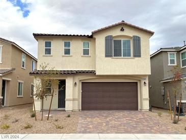 Two-story house with brown garage door and neutral color scheme at 9868 Angel Valley Dr, Las Vegas, NV 89178