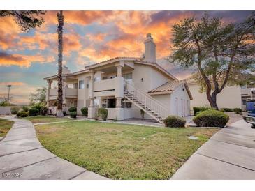 Two-story condo with walkway and landscaping at 1300 Pinto Rock Ln # 201, Las Vegas, NV 89128