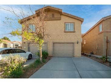 Two-story house with attached garage and driveway at 4793 Woodland Ave, Las Vegas, NV 89121