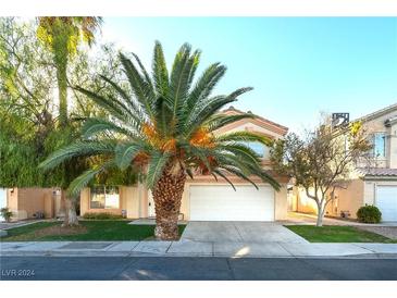 Two-story house with a palm tree in the front at 7341 Tealwood St, Las Vegas, NV 89131