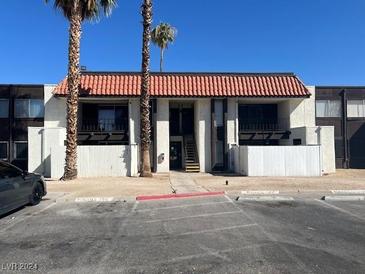 Two-story building with Spanish tile roofs and ample parking at 1405 Vegas Valley Dr # 211, Las Vegas, NV 89169