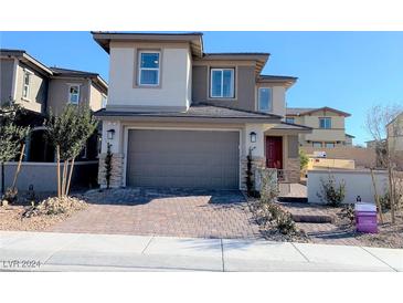 Two story house with gray siding and two car garage at 107 Orchestral Ln, Henderson, NV 89011