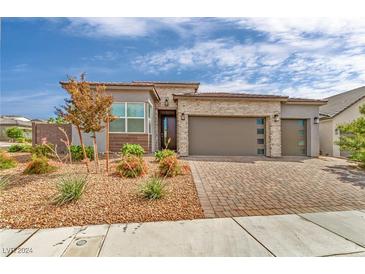 Modern home with two-car garage and landscaped front yard at 3367 Peak View Ave, Henderson, NV 89044