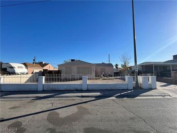 Single story home with gated front yard at 613 E Bartlett Ave, North Las Vegas, NV 89030