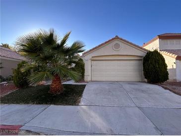 Two-story house with attached garage and desert landscaping at 1705 Imperial Cup Dr, Las Vegas, NV 89117