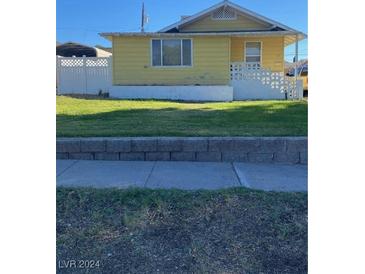 Yellow bungalow with front yard at 635 California Ave, Boulder City, NV 89005