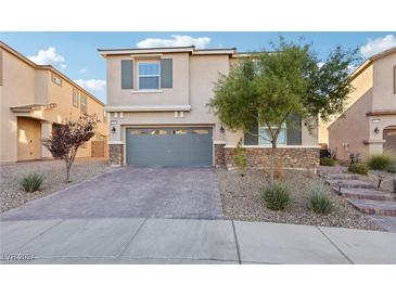 Two-story house with gray garage door and brick walkway at 969 Cutter St, Henderson, NV 89011