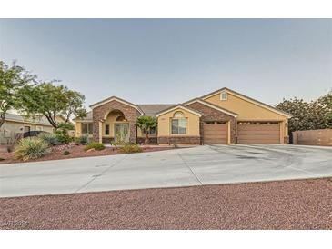 Single-story home with a three-car garage and landscaped yard at 8420 Lake Tahoe View Ct, Las Vegas, NV 89143