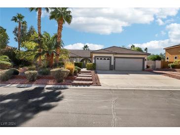 Two-story house with landscaped yard and attached garage at 8371 Las Lunas Way, Las Vegas, NV 89129