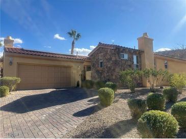 Single-story home with stone accents and a two-car garage at 1159 Calcione Dr, Henderson, NV 89011