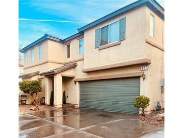 Two-story house with a green garage door at 9927 Copano Bay Ave, Las Vegas, NV 89148