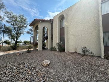 Exterior view of a two-story building with a staircase and landscaping at 4464 W Desert Inn Rd # A, Las Vegas, NV 89102