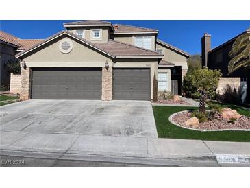 Two-story house with three-car garage and landscaping at 8506 Lambert Dr, Las Vegas, NV 89147