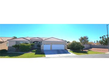 Single-story house with a two-car garage and landscaped yard at 735 Diamond Bend Ave, Las Vegas, NV 89123