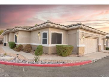 Tan two-story home with attached garage and landscaping at 2285 Canyon Song Ave, Laughlin, NV 89029