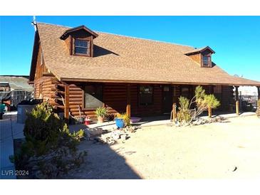 Rustic log cabin home with a large covered porch and expansive yard at 3900 W Landberg Ave, Las Vegas, NV 89141