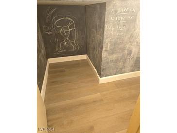 Basement play room with chalkboard walls and wood-look flooring at 3968 Steinbeck Dr, Las Vegas, NV 89115