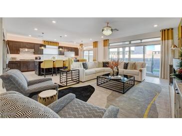 Open living room with modern furniture and kitchen island view at 7208 Grace Estate Ave, Las Vegas, NV 89113