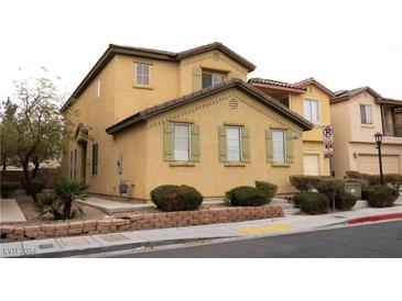 Two-story house with tan siding, green shutters, and a landscaped front yard at 3519 Hammock St, Las Vegas, NV 89147