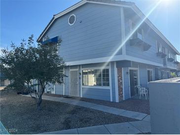 Charming blue two-story home with a landscaped front yard and pathway at 5330 Duralite St # 102, Las Vegas, NV 89122