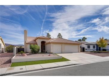 Single-story house with three-car garage and desert landscaping at 134 Skytop Dr, Henderson, NV 89015