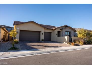 Modern home with three-car garage and attractive landscaping at 169 Bella Noche St, Las Vegas, NV 89138