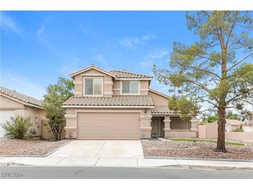 Two-story house with attached garage and landscaping at 4337 Threshold Ct, North Las Vegas, NV 89032