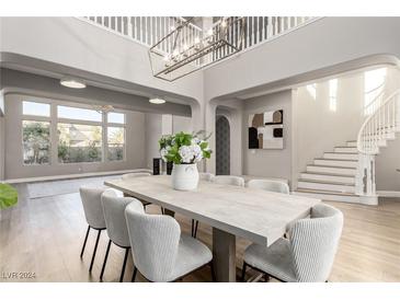 Elegant dining room with large table and chandelier at 7208 Iron Oak Ave, Las Vegas, NV 89113