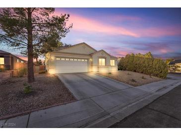 Single-story house with a two-car garage and landscaped front yard at 4125 Allyson Rae St, North Las Vegas, NV 89032