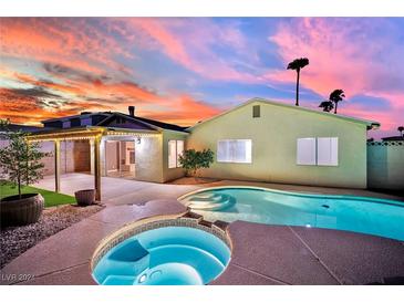 Backyard oasis with a pool, spa, and covered patio, perfect for entertaining under the desert sunset at 4623 Kearney St, Las Vegas, NV 89147