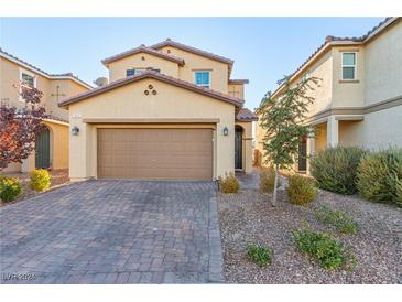 Two-story house with a two-car garage and landscaped front yard at 2815 Donatello Manor Pl, Henderson, NV 89044