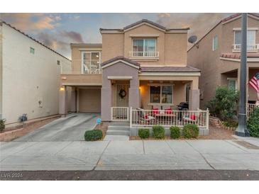 Two-story house with front porch and landscaped yard at 9061 Intriguing Ave, Las Vegas, NV 89149