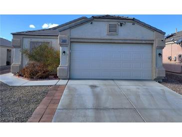 One-story house with a two-car garage and landscaped front yard at 5909 Mount Auburn St, Las Vegas, NV 89130