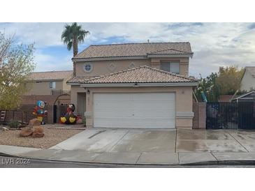 Two-story house with a landscaped yard and attached garage at 1071 Nordyke Ave, Henderson, NV 89015