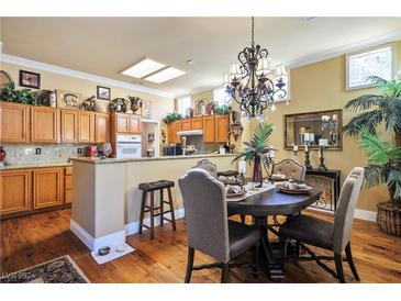 Spacious kitchen with wood cabinets, granite countertops, and hardwood floors at 10600 Cedar Creek Ave, Las Vegas, NV 89134