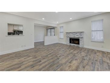 Bright living room featuring a fireplace and wood-look floors at 2125 Sun Ave # A, North Las Vegas, NV 89030