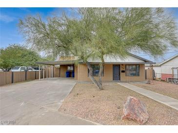 Ranch style home with carport, landscaped yard, and walkway at 106 Manganese St, Henderson, NV 89015