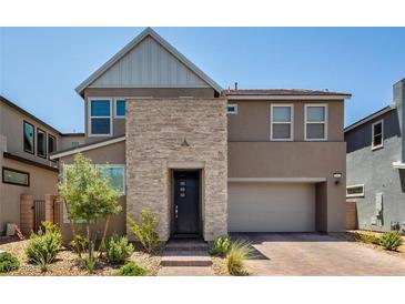 Two-story modern home with stone accents and landscaped front yard at 2661 Skylark Trail St, Henderson, NV 89044