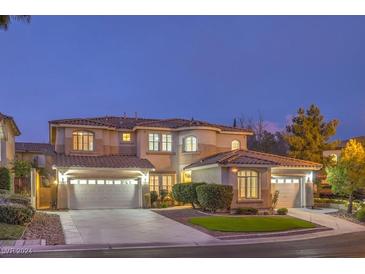 Two-story house with a three-car garage, landscaping, and a well-maintained front yard at 11368 Rancho Portena Ave, Las Vegas, NV 89138