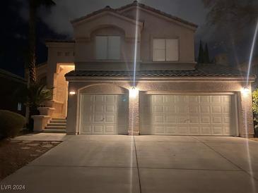 Two-story house with a two-car garage, nighttime view at 2277 Black Pine Dr, Las Vegas, NV 89134